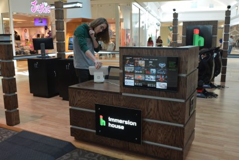 Hayden Head of Immersion House looks over the displays at the virtual reality gaming store inside the Sooner Mall in Norman, Oklahoma. Gaylord News/Trinity Cohee