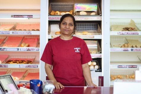 Dipti Patel stands behind the counter of her Donut King shop on Lindsey Street after the morning rush. She and her husband, Sanjay Patel, bought the shop in 1994, when it was a Dunkin’ Donuts franchise. Megan Ross / The Daily