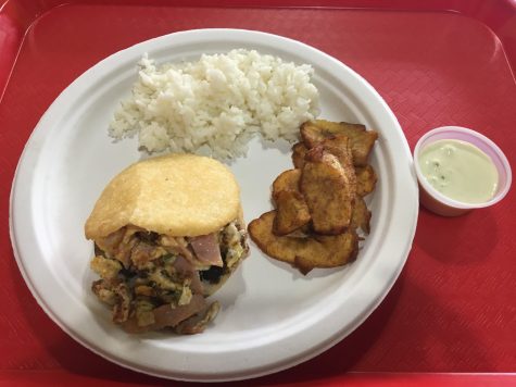 An arepa served with fried plantains and rice.