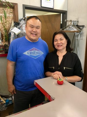 Kim’s Alterations, Inc. owner Kim Lu and her son Dennis Lu pose inside Lu’s alterations shop of 34 years.