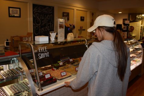 University of Oklahoma student Peyton Brougher purchases a dessert from Apple Tree Chocolates on Campus Corner in Norman. Apple Tree Chocolates offers chocolate-dipped fruit, fudge, baked goods and much more.