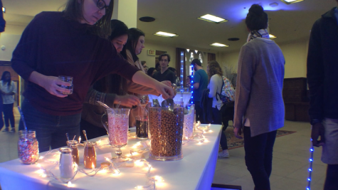 University of Oklahoma students top up their cocoa during an event held yesterday in the Oklahoma Memorial Union.