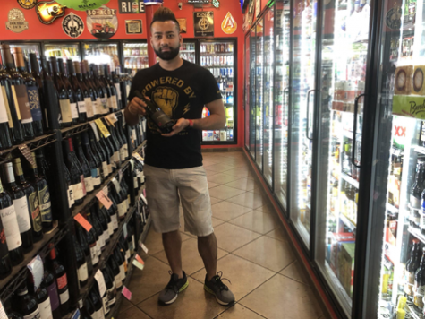 Daniel Joshi, founder of Rosedale Market, holds his favorite
wine selection from the store inventory on March 22, 2018,
in Austin, Texas. The corner store has stocked over 900
variations of wine and champagne.