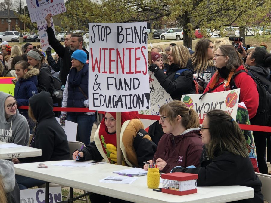 Gracie Stell, a senior at Edmond Memorial High School, attending class at the Capitol wearing a hot dog costume while holding a sign for the Oklahoma teacher walkout April 2, 2018. 
