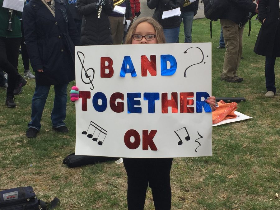 A young girl holds a sign in support of the "walkout band" that participated in the Oklahoma teacher walkout at the state capitol April 2. People of all ages attended the walkout in support of fine arts.