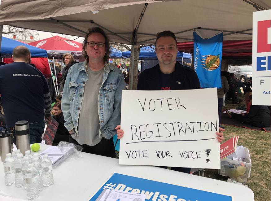 James Edmondson and Grant Hale encourage protestors to registor to vote outside of the Oklahoma State Capitol on April 6. Both have been at the Capitol all week and have felt encouraged by the number of young Oklahomans that have registered.