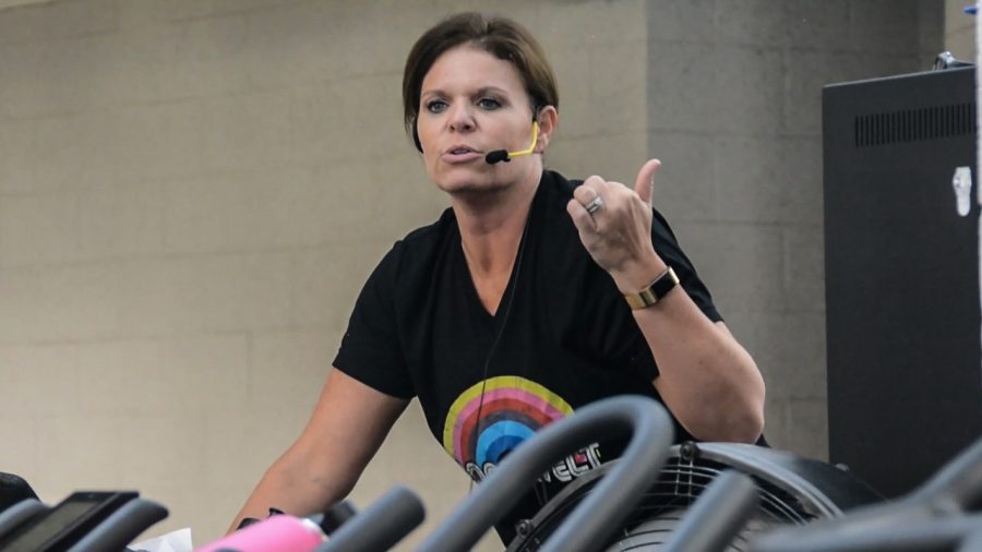 Renee Williams teaches her Monday cycling power class and talks through the workout to help keep the class motivated. Cycling classes are one of the classes that get overbooked easily, so the new Fitness and Recreation app will help those who want to take the class make a reservation. Photo by: Bailey Lewis/OU News Crowd.