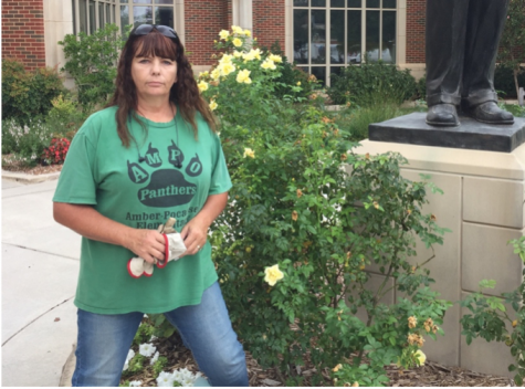 University of Oklahoma landscaping specialist Tammie Mitchell stands in front of surviving roses in the Gaylord courtyard on Sept. 10. Many of OU campus roses have been killed by a virus called Rose Rosette or witches’ broom.