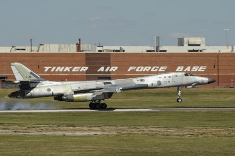 A mostly natural metal Boeing B-1B Lancer is shown moments after the main landing gear tires have touched the runway at the end of a post-maintenance check-flight with the 10th Flight Test Squadron, Air Force Reserve Command, June 20, 2017, Tinker Air Force Base, Oklahoma. The large building behind the B-1B is building 3001, a former Douglas Aircraft manufacturing plant during World War II, now used by the Oklahoma City Air Logistics Complex and its parent organization the Air Force Sustainment Center. The B-1B is being flown by a highly-experienced crew from the 10th FLTS to ensure the aircraft and systems are fully functional following depot level maintenance conducted at the OC-ALC. Once the aircraft passes all checks it will be painted and then re-delivered for front-line service. (U.S. Air Force photo/Greg L. Davis)