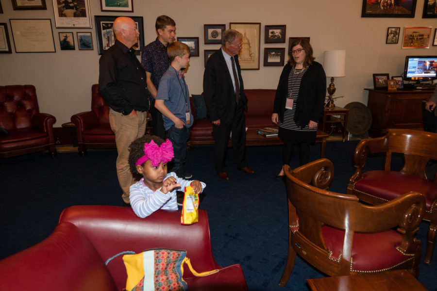 3-year-old Addi Belt takes candy from her moms bag while her parents speak with Oklahoma Senator Jim Inhofe across the room. Inhofe advocated for the family during the difficult process of adopting Addi from Ethiopia. (Megan Ross / Gaylord News)