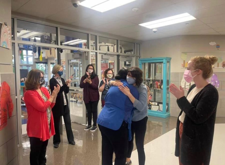 Cafeteria+manager+Yanet+Viamontes+hugs+library+assistant+Mais+Shalabi+in+the+hallway+at+Prairie+Vale+Elementary+School.+The+staff+celebrated+Viamontes+with+chants+and+applause+after+she+passed+her+citizenship+exam.+%28Photo+provided+by+Prairie+Vale+Elmentary+School%29