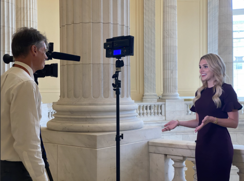 Alex Cameron, Washington D.C. correspondent of News 9, interviews Gaylord News reporter Libbey Dean in the Cannon Rotunda. (Gaylord News/ Vy Luong)