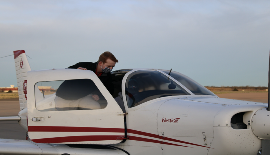 Field Parsons stands on an aircraft at the Max Westheimer airport on March 24. (Gaylord News/ Zaria Oates)