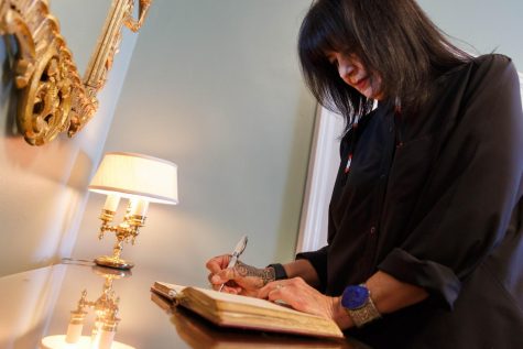 -Joy Harjo signs into the Poetry and Literature Centers historic guest book as the nations 23rd poet laureate. (Shawn Miller/Library of Congress)
