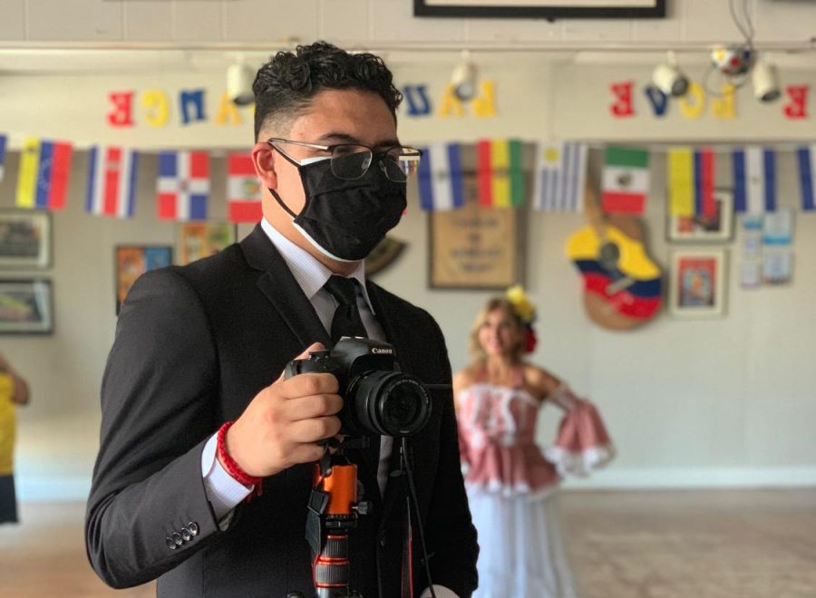 Kevin Palomino on assignment for a story for Hispanic Heritage Month at Clips and Hips, a bilingual dance studio and hair salon in Oklahoma City. (Gaylord News/Pamela Ortega)
