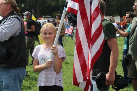 - A child holds United States flag while attending the Justice for J6 rally at the U.S. Capitol on Saturday, Sept. 18. (Gaylord News/ Zaria Oates)
 