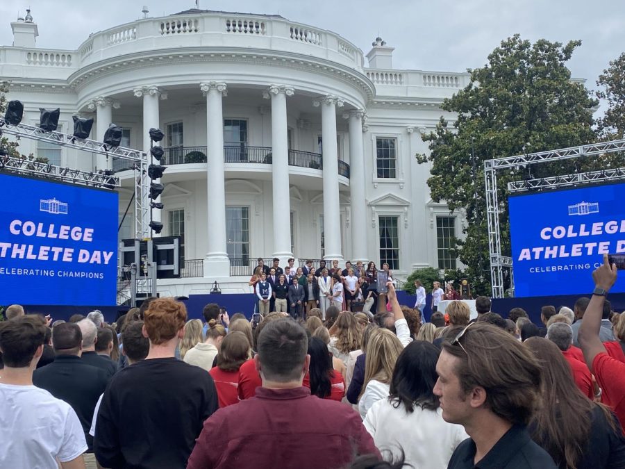 Representatives of the 47 student athletes assemble on stage on the South Lawn at the White House before Vice President Kamala Harris speaks at College Athlete Day.  (Photo by Ben Dackiw/Gaylord News)
