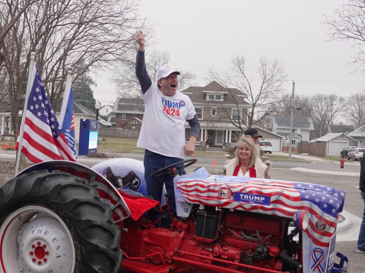 Gary+Leffler%2C+Trump+Caucus+captain%2C+stands+on+his+tractor+to+excite+the+crowd+outside+a+rally+in+Newton%2C+Iowa.+Kevin+Eagleson%2FGaylord+News%0A