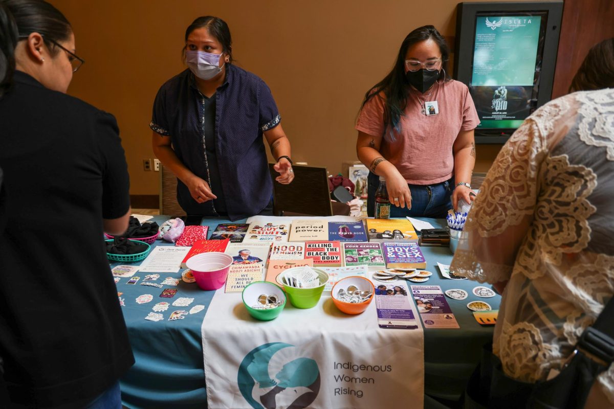 Sandy Harris, left, and Jonnette Paddy, right, with Indigenous Women Rising talk about abortion care and reproductive health with attendees at the “Women Are Sacred” conference on June 27, 2023, in Albuquerque, N.M. (Photo by Noel Lyn Smith/News21)