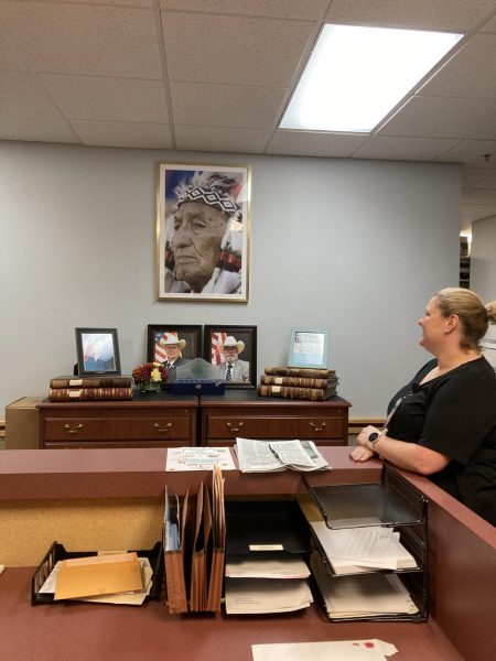 Administrative Assistant Ashlee Culliver has been with the sheriff’s office for less than a year so never worked across the room from the likeness of George Armstrong Custer. A portrait of Arapaho Chief Moses Starr now hangs in its place. (Photo by Kimberly Burk)