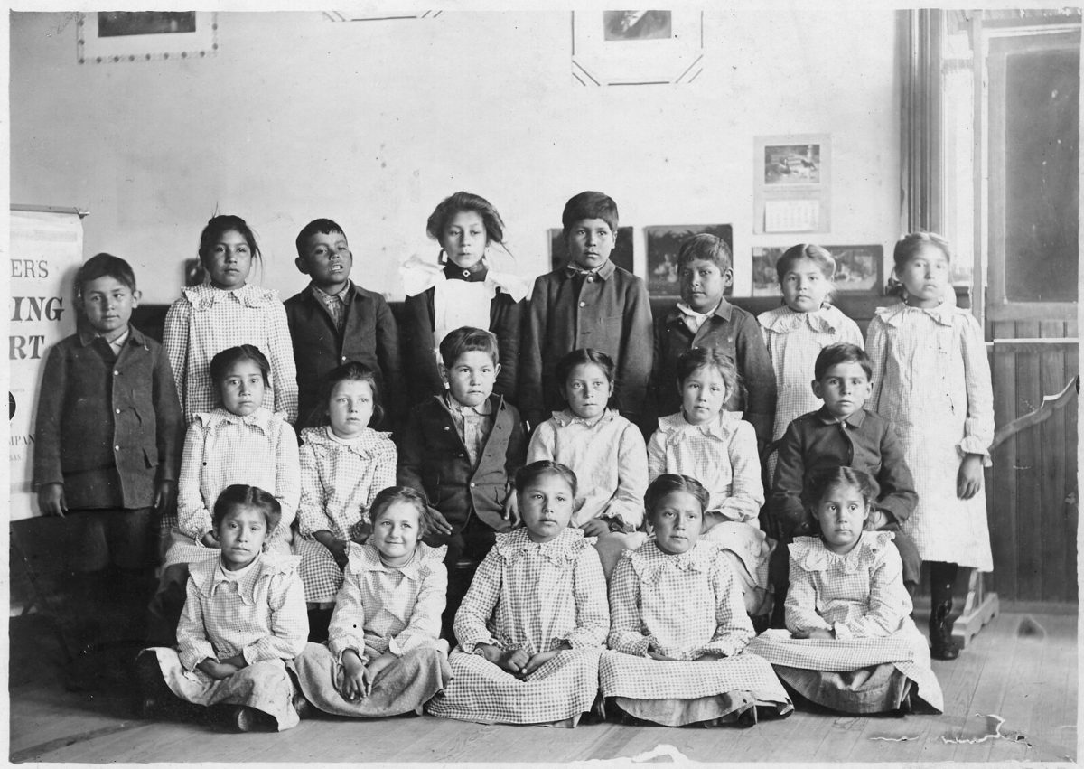 Native American students at Seneca Indian Boarding School from a number of local tribes gather for a class photograph, taken around 1905 by Charles R. Scott, an employee of the school. Courtesy of National Archives and Records Administration