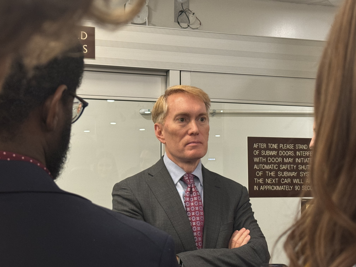 Sen. James Lankford (R-Oklahoma) speaks to reporters in the Senate subway on his way to a vote on Nov. 18. Ireland Fitzer/Gaylord News