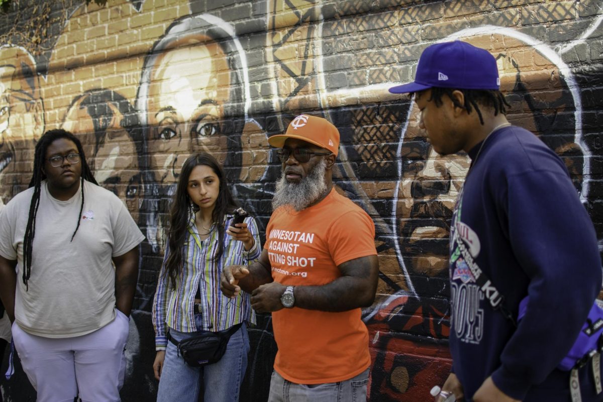 Marquise Bowie, one of the founders of Agape, takes the Voices of Resilience team on a tour of George Floyd Square. Left to right are LJ Golston, Ana Castillo, Bowie and Cameron Williams.  