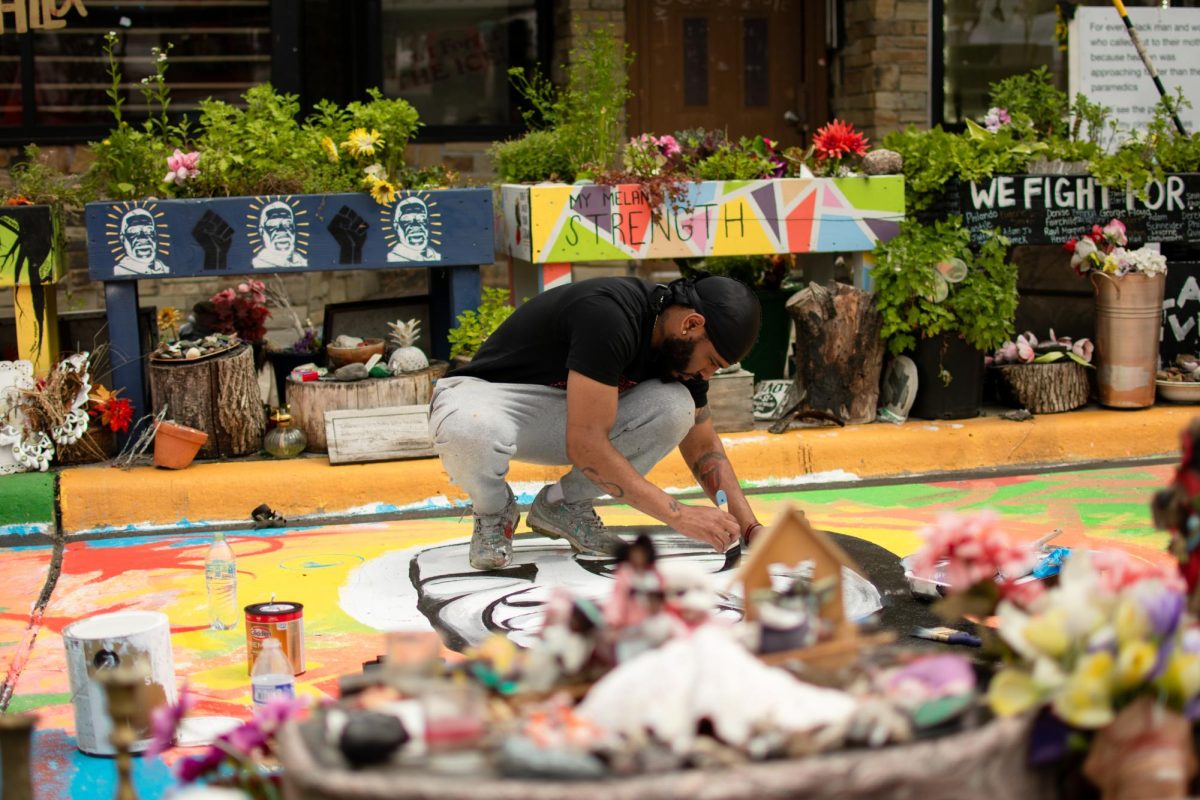 Popeye Not Picasso painting a street portrait of George Floyd on the fourth anniversary of his death. Popeye creates a Floyd mural on the spot where he died on every May 25th anniversary. PHOTO: Maria Nairn