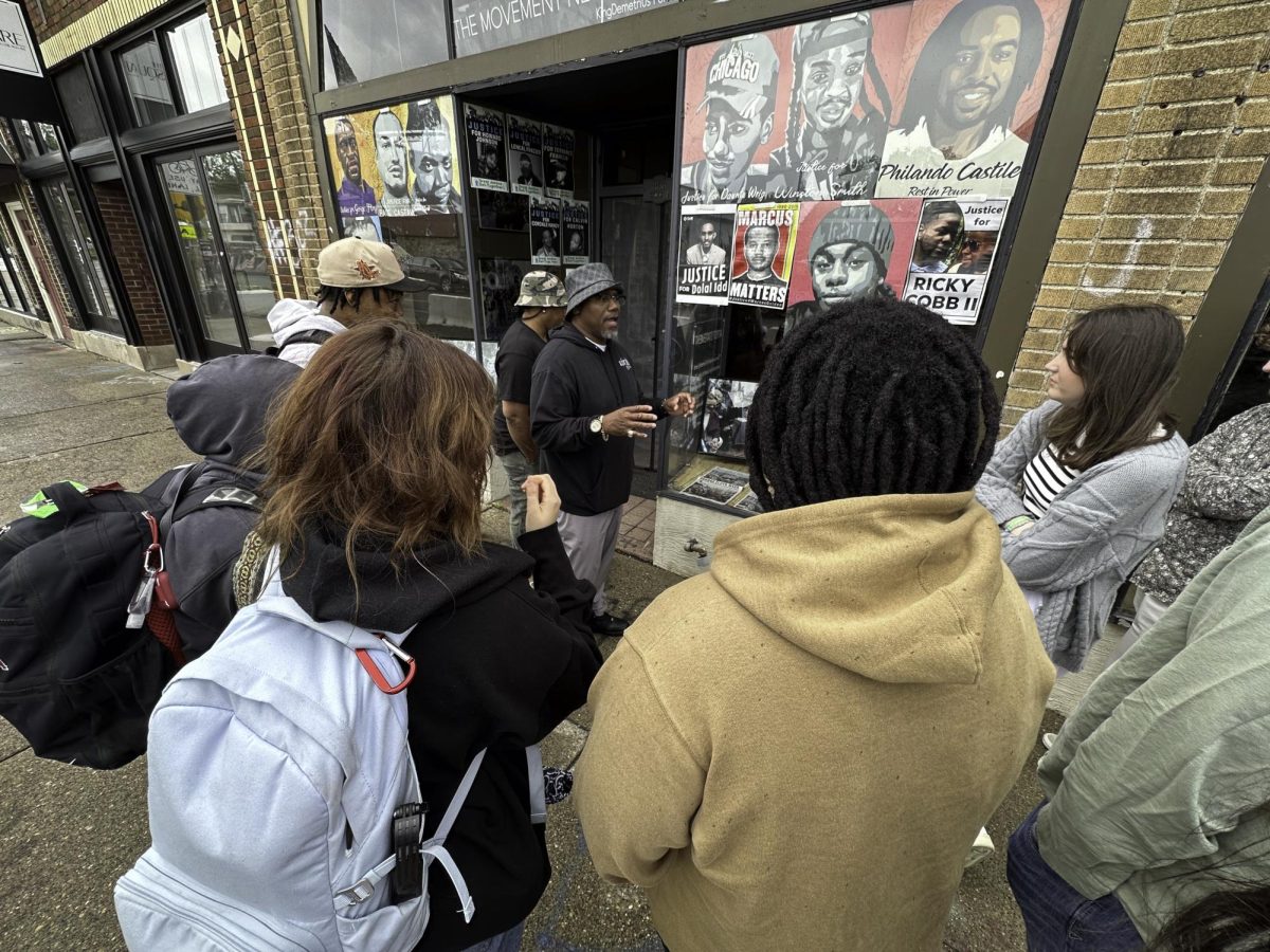 The Voices of Resilience team meeting with KingDemetrius Pendleton outside of his Listen Media gallery in George Floyd Square.  Pendleton’s work documenting racial protests and advocacy in the Twin Cities region has spanned decades. 
