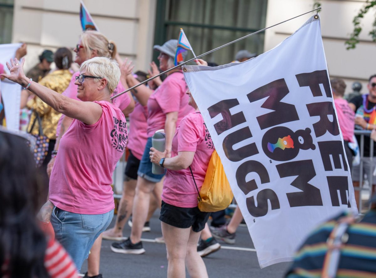 Free Mom Hugs founder Sara Cunningham marches with a flag during the WorldPride Parade in D.C.