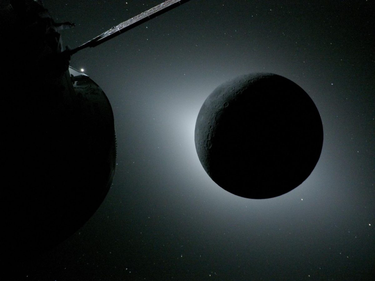 The Moon, backlit by the Sun during a solar eclipse, is photographed by NASA’s Orion spacecraft on Monday, April 6, 2026, during the Artemis II mission. Orion is visible in the foreground on the left. Earth is reflecting sunlight at the left edge of the Moon, which is slightly brighter than the rest of the disk. The bright spot visible just below the Moon’s bottom right edge is Saturn. Beyond that, the bright spot at the right edge of the image is Mars. NASA/Gaylord News
